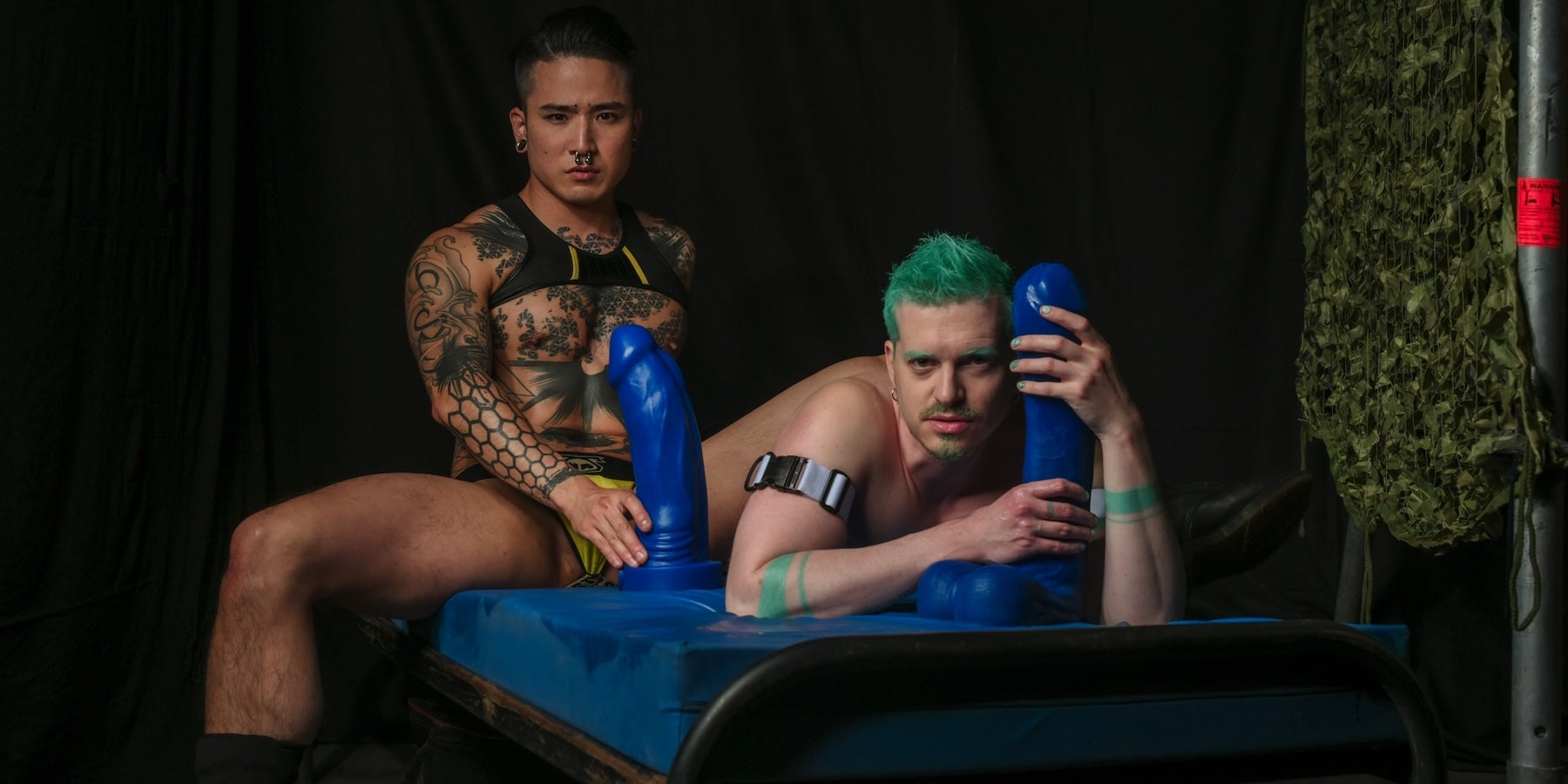 Couple holding two blue Crackstuffers Adult Toys